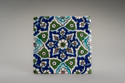 Lot 2184 - A QAJAR TILE WITH A GEOMETRIC FLORAL DESIGN