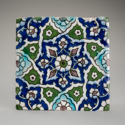 Lot 1296 - A QAJAR TILE WITH A GEOMETRIC FLORAL DESIGN
