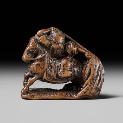 Lot 210 - SHOUNSAI JORYU: A WOOD NETSUKE OF KWANYU ON HORSEBACK