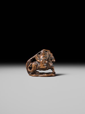 Lot 210 - SHOUNSAI JORYU: A WOOD NETSUKE OF KWANYU ON HORSEBACK