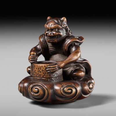 Lot 227 - HOSHUNSAI MASAYUKI: A FINE WOOD NETSUKE OF A RAIJIN ON A CLOUD