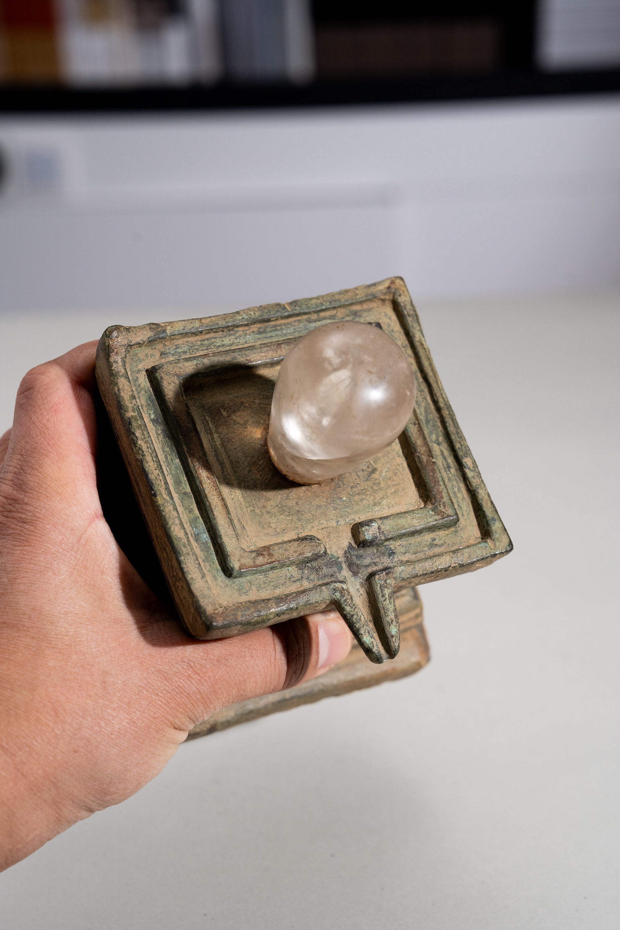 Lot 682 - A ROCK CRYSTAL LINGA AND BRONZE YONI, ANGKOR