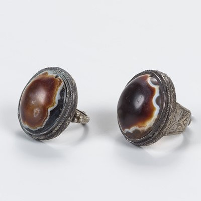 Lot 693 - A LOT WITH TWO HIMALAYAN BUDDHA EYE AGATE INSET SILVER RINGS