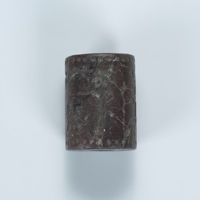 Lot 2071 - A STONE CYLINDER SEAL WITH FIGURES AND ANIMALS