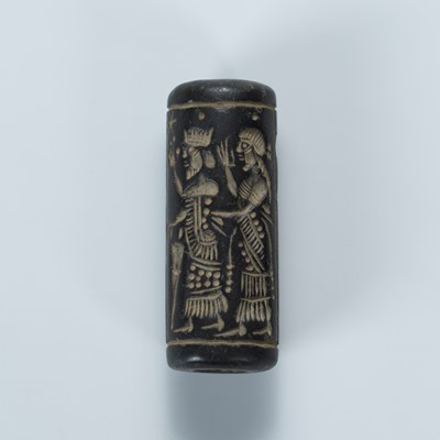 Lot 2072 - A BLACK STONE CYLINDER SEAL WITH FIGURES