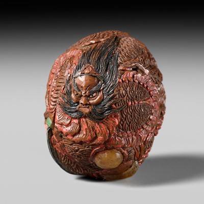 Lot 522 - A LACQUERED AND INLAID KURUMI (WALNUT) NETSUKE OF SUSANOO SLAYING YAMATA NO OROCHI