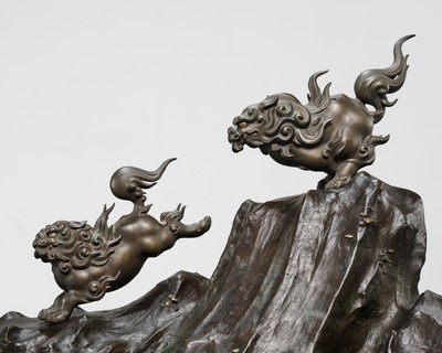 Lot 3 - KATO TATSUO: AN IMPRESSIVE BRONZE OKIMONO OF TWO LEAPING SHISHI ON ROCKWORK