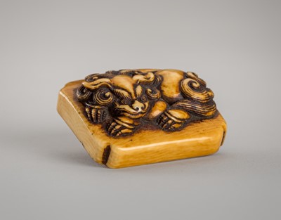 Lot 1250 - A RENSAI STYLE IVORY NETSUKE OF A SHISHI