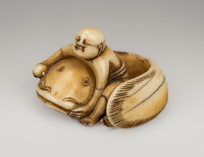 Lot 1299 - AN IVORY NETSUKE OF FISHERMAN TAMING THE NAMAZU