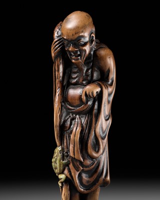 Lot 194 - A SUPERB TALL WOOD NETSUKE OF GAMA SENNIN WITH A GREEN-STAINED ANTLER TOAD