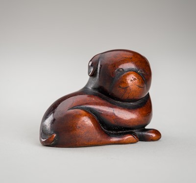 Lot 1391 - A WOOD NETSUKE OF A CHUBBY PUPPY