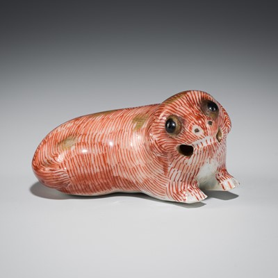 Lot 534 - A PORCELAIN NETSUKE OF A RECUMBENT DOG