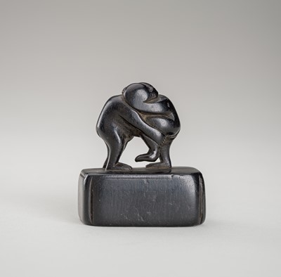 Lot 1351 - AN EBONY NETSUKE OF TWO MONKEYS WRESTLING