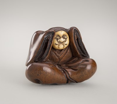 Lot 361 - MIWA: A FINE INLAID WOOD NETSUKE OF A KARAKO WITH A BUAKU MASK