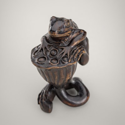 Lot 1424 - VASILY PATOKIN: A WOOD NETSUKE OF A FROG ON A LOTUS POD