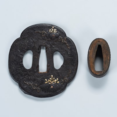 Lot 1473 - AN IRON TSUBA WITH PAULOWNIA LEAVES AND A MATCHING IRON FUCHI WITH VINES