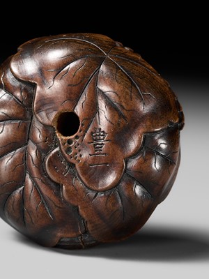 Lot 164 - TOYOKAZU: A VERY FINE WOOD RYUSA MANJU NETSUKE DEPICTING KIRI NO HO-O