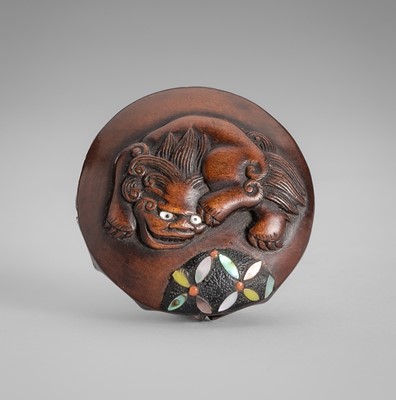 Lot 1729 - A RARE INLAID MANJU WOOD NETSUKE WITH A SHISHI