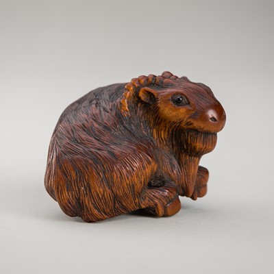 Lot 457 - A WOOD NETSUKE OF A RECUMBENT GOAT