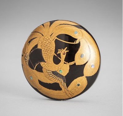 Lot 1766 - A SIGNED, BLACK-LACQUERED WOOD MANJU NETSUKE WITH A PEACOCK