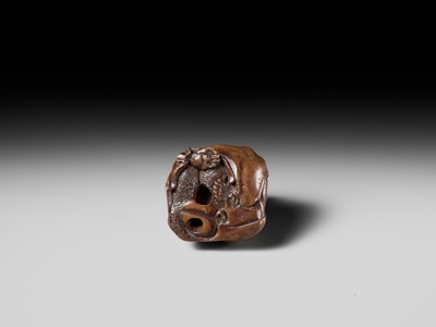 Lot 243 - A FINE AND HUMOROUS WOOD NETSUKE OF TANUKI DISGUISED AS A PRIEST