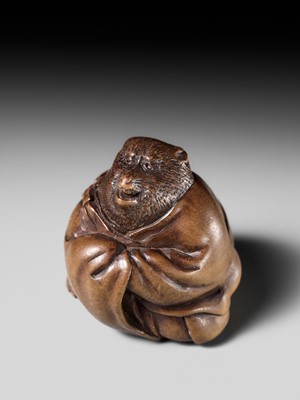 Lot 243 - A FINE AND HUMOROUS WOOD NETSUKE OF TANUKI DISGUISED AS A PRIEST