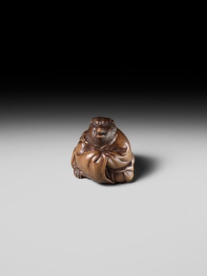 Lot 243 - A FINE AND HUMOROUS WOOD NETSUKE OF TANUKI DISGUISED AS A PRIEST