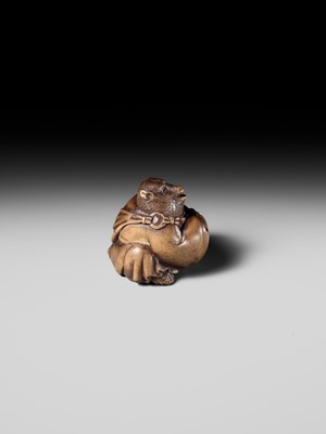 Lot 243 - A FINE AND HUMOROUS WOOD NETSUKE OF TANUKI DISGUISED AS A PRIEST