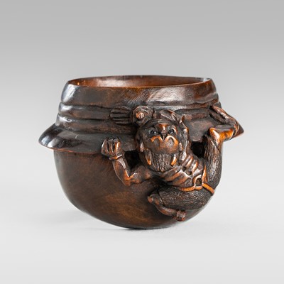 Lot 1588 - A SIGNED AND RARE WOOD NETSUKE OF AN ONI ON A CHAGAMA (TEA KETTLE)