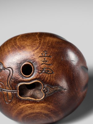 Lot 229 - HOSHUNSAI MASAYUKI: A FINE WOOD NETSUKE OF HOTEI IN HIS TREASURE BAG