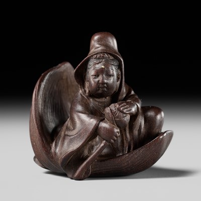 Lot 275 - TOSHICHIKA: A VERY FINE TOKYO SCHOOL WOOD NETSUKE OF KANNON IN A LOTUS BOAT