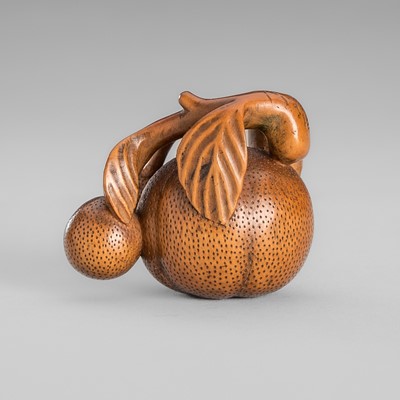 Lot 1662 - YOSHIKIYO: AN ANABORI WOOD NETSUKE OF A BRANCH OF MIKAN (TANGERINES)