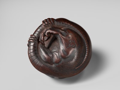 Lot 149 - MASAKAZU: A MASTERFUL WOOD NETSUKE OF A RAT GROOMING ITSELF