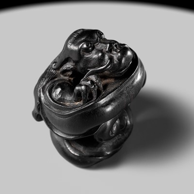 Lot 223 - HO RAKUMIN: A FINE EBONY WOOD NETSUKE OF A COILED AMARYU (RAIN DRAGON)