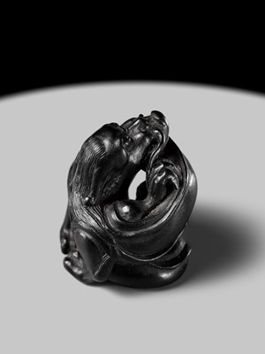 Lot 223 - HO RAKUMIN: A FINE EBONY WOOD NETSUKE OF A COILED AMARYU (RAIN DRAGON)