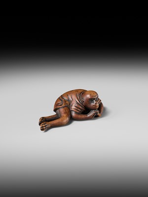 Lot 222 - JOBUN: A SUPERB WOOD NETSUKE OF A RECLINING MONKEY