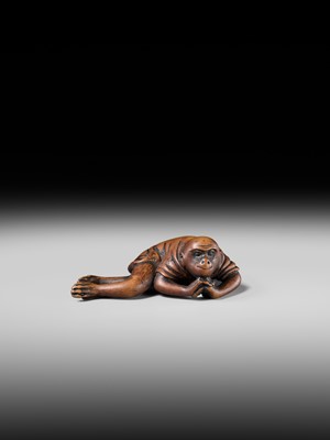 Lot 222 - JOBUN: A SUPERB WOOD NETSUKE OF A RECLINING MONKEY