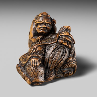 Lot 454 - SHIGENOBU: A FINE WOOD NETSUKE OF AN ONI MASSAGING SHOKI