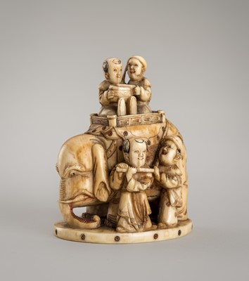 Lot 1405 - AN IVORY OKIMONO NETSUKE OF AN ELEPHANT WITH A GROUP OF KARAKO