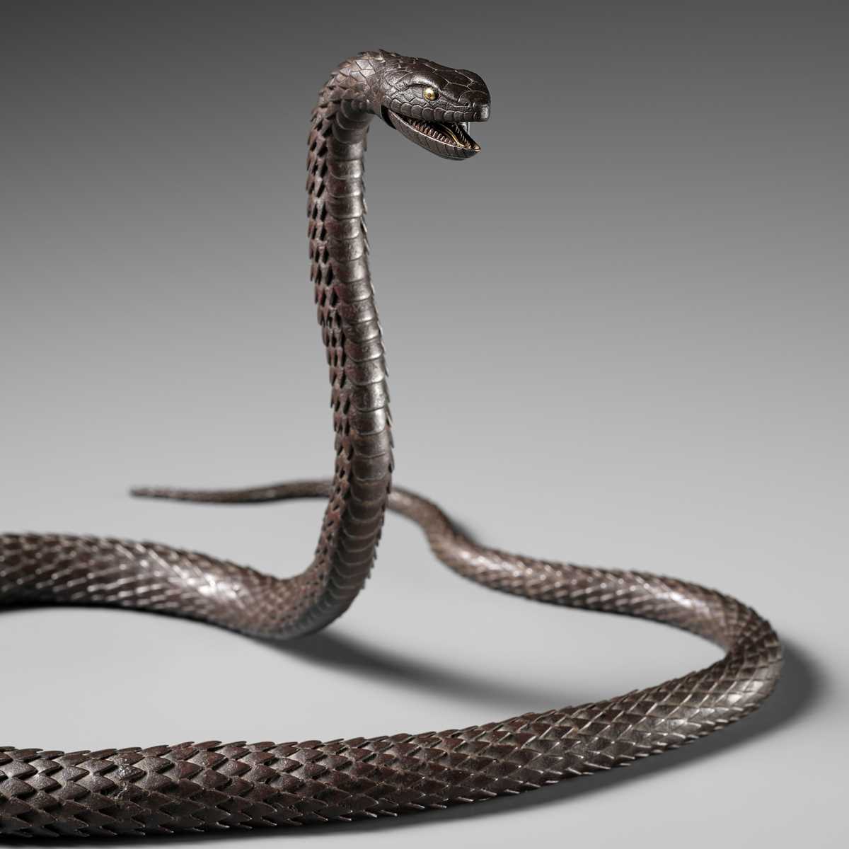 Lot 81 - MUNEYOSHI: A MASTERFUL AND LARGE IRON JIZAI OKIMONO OF A SNAKE