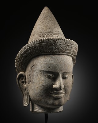 Lot 259 - A SANDSTONE HEAD OF A MALE DIVINITY, ANGKOR WAT STYLE, 12TH CENTURY