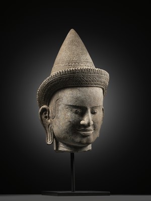 Lot 259 - A SANDSTONE HEAD OF A MALE DIVINITY, ANGKOR WAT STYLE, 12TH CENTURY