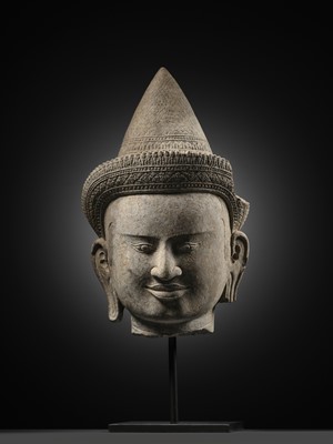 Lot 259 - A SANDSTONE HEAD OF A MALE DIVINITY, ANGKOR WAT STYLE, 12TH CENTURY