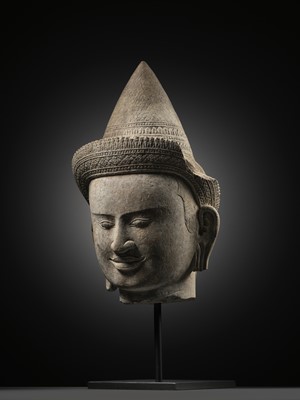 Lot 259 - A SANDSTONE HEAD OF A MALE DIVINITY, ANGKOR WAT STYLE, 12TH CENTURY