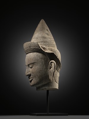 Lot 259 - A SANDSTONE HEAD OF A MALE DIVINITY, ANGKOR WAT STYLE, 12TH CENTURY