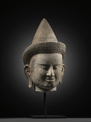 Lot 259 - A SANDSTONE HEAD OF A MALE DIVINITY, ANGKOR WAT STYLE, 12TH CENTURY