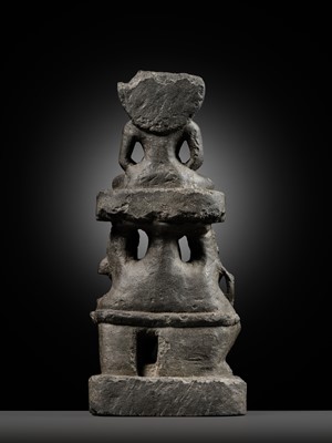 Lot 334 - A BLACK STONE STELE DEPICTING AN ENTHRONED MAHAVIRA ATTENDED BY A YAKSHA AND YAKSHI, PALA PERIOD, 11TH-12TH CENTURY