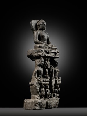 Lot 334 - A BLACK STONE STELE DEPICTING AN ENTHRONED MAHAVIRA ATTENDED BY A YAKSHA AND YAKSHI, PALA PERIOD, 11TH-12TH CENTURY