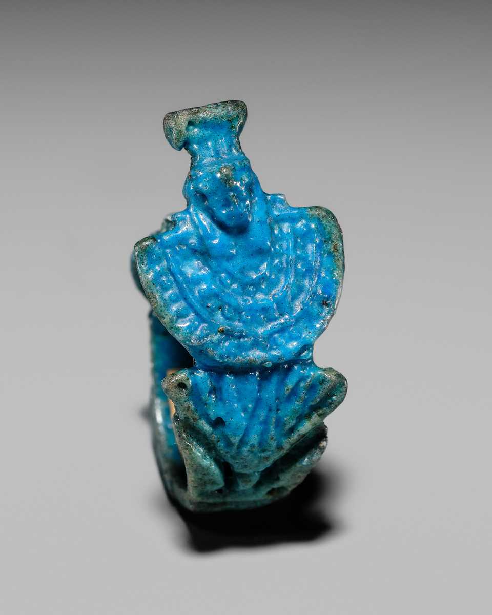 Lot 46 - A RARE TURQUOISE GLAZED FAIENCE RING WITH AEGIS OF NEPHTHYS, THIRD INTERMEDIATE PERIOD, DYNASTY XXII