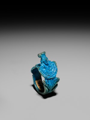 Lot 46 - A RARE TURQUOISE GLAZED FAIENCE RING WITH AEGIS OF NEPHTHYS, THIRD INTERMEDIATE PERIOD, DYNASTY XXII